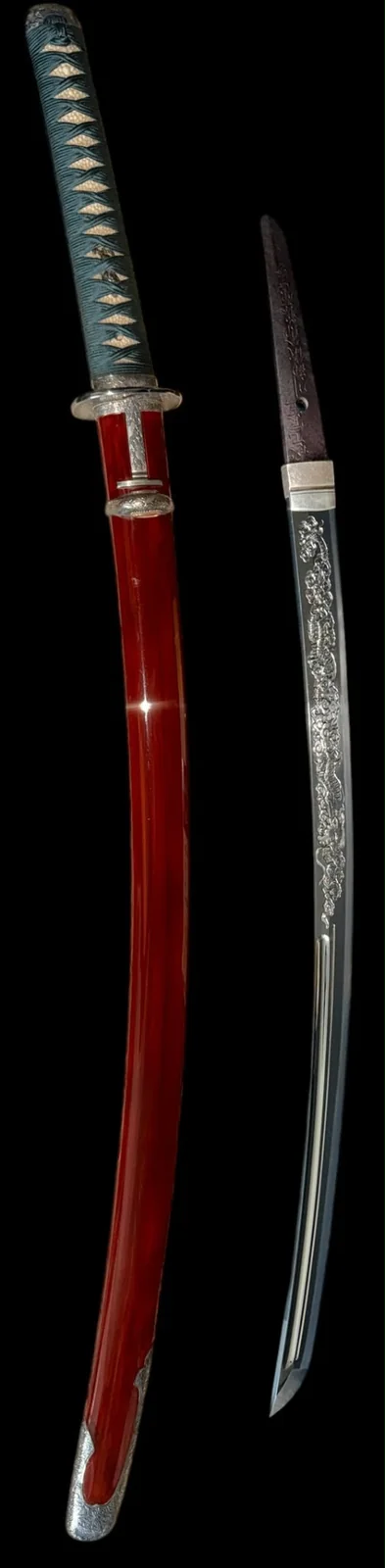 Detail view of the vermilion lacquer saya and tsuka of the Suishinshi Masahide wakizashi beside the polished blade showing the silver dragon horimono and active hamon